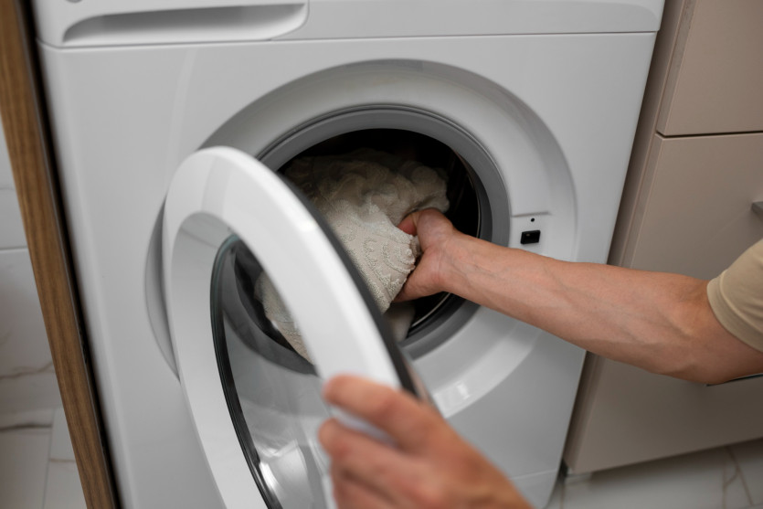 1677830119.0136high-angle-adult-loading-the-washing-machine.jpg